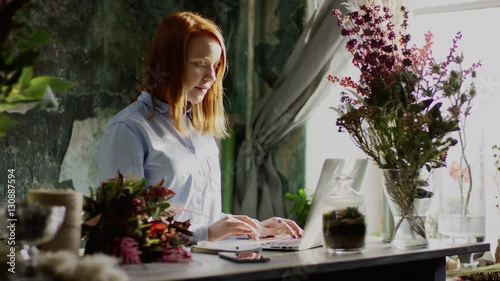 florist typing on laptop