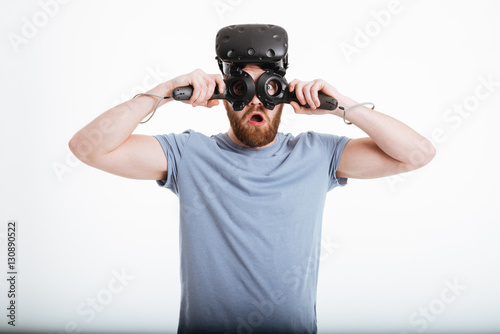 Playful man wearing virtual reality device