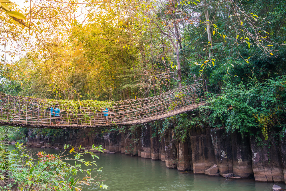 Bridge wood crossing Phasom Waterfall (Tad) in tropical country, Laos