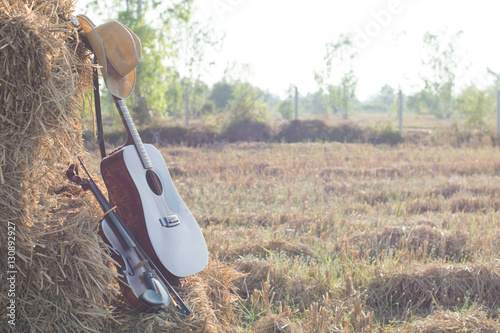 guitar and violin resting on straw Division in the fields, the w