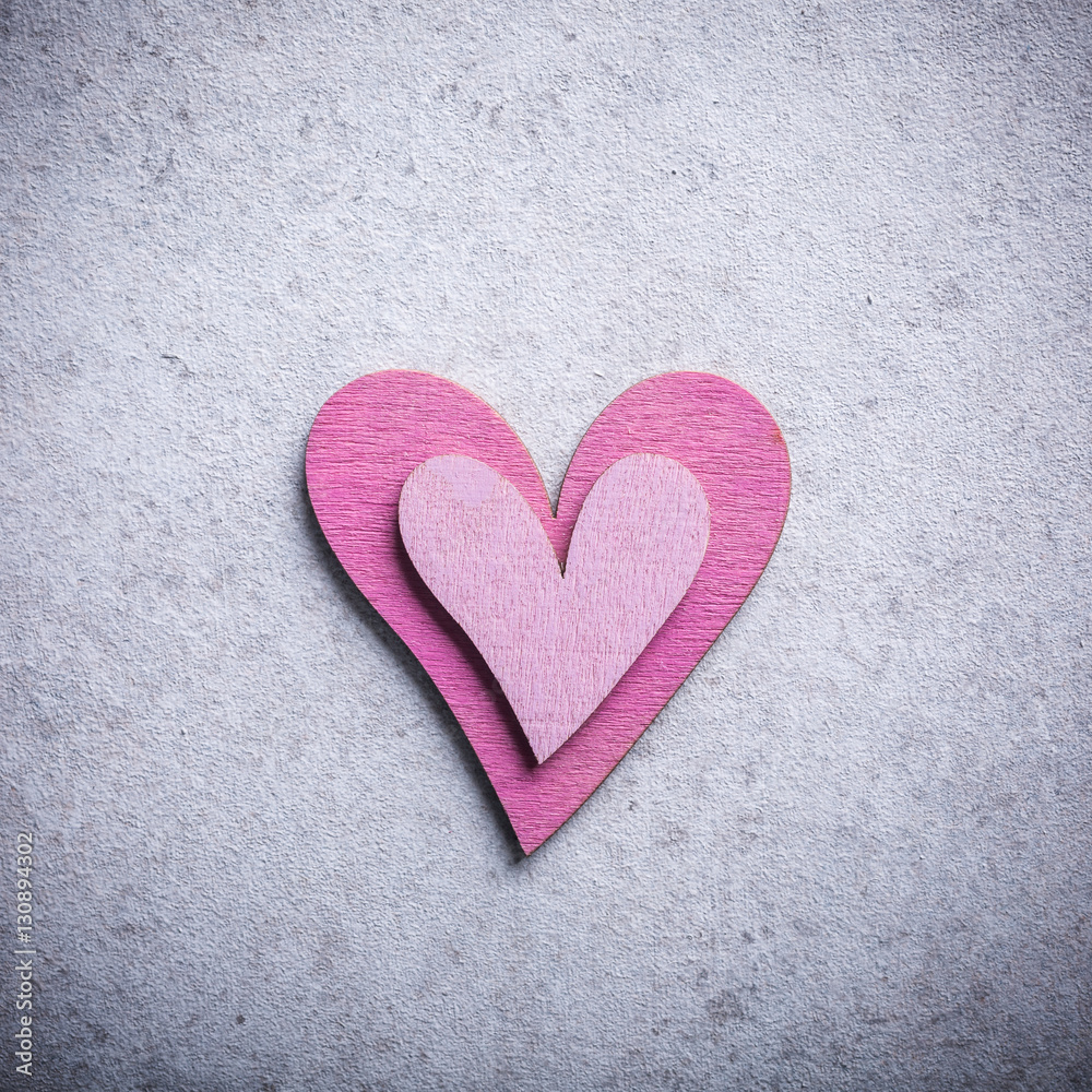 Valentines Day background with decorative pink wooden heart on concrete stone with copy space for text. Valentine's Day concept. View from above.