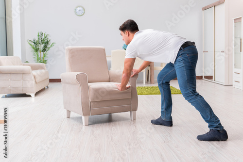 Man moving furniture at home © Elnur