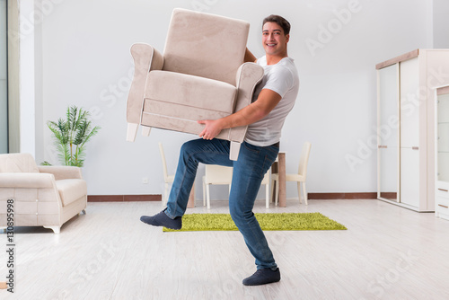 Man moving furniture at home