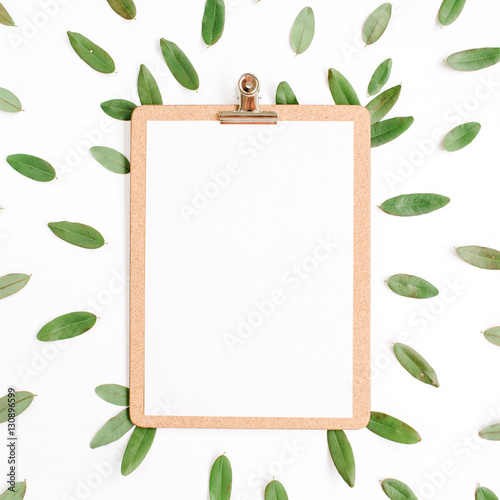 clipboard with green petals isolated on white background. flat lay, top view