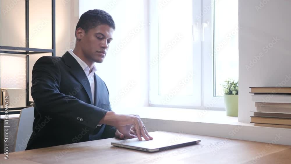 Black Businessman Coming to Office, Starts Work on Laptop Black Businessman Coming to Office, Starts Work on Laptop