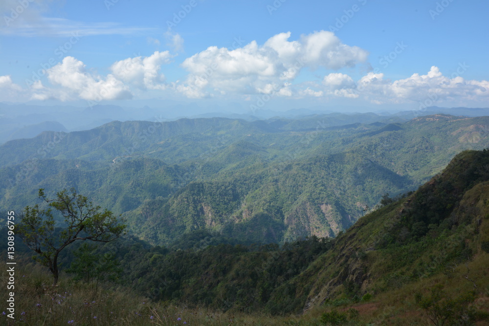 view on top mountain with blue sky at sunny day. subject is blurred