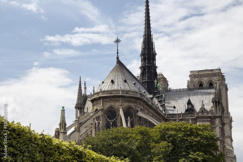 Back view of Notre Dame Cathedral in Paris. Towering, 13th-century cathedral with flying buttresses & gargoyles, setting for Hugo's novel.