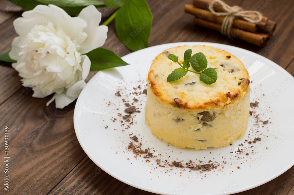 Curd pudding with raisins. Wooden rustic table. Close-up. Top view Curd pudding with raisins. Wooden rustic table. Close-up. Top view