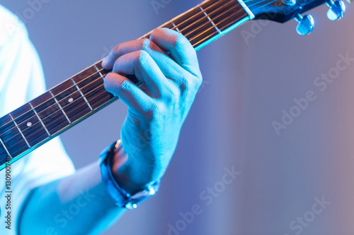 Hands of a musician playing an electric guitar. photo