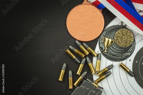 Shooting competition. Award winners. Biathlon victory. Ammunition and winners medals in biathlon. Diploma of shooting competitions. Background diploma.
 photo