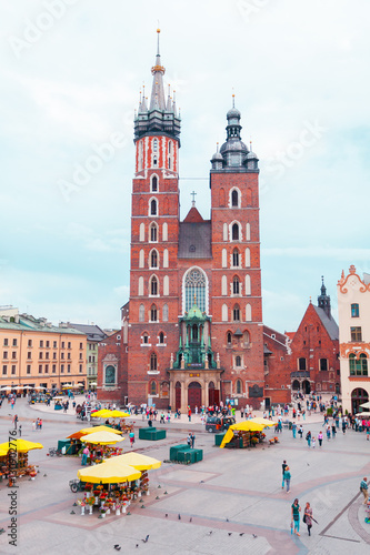 Church of St. Mary in the main Market Square on the background of dramatic sky. Basilica Mariacka. Krakow. Poland.