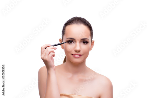 Woman getting make-up isolated on white