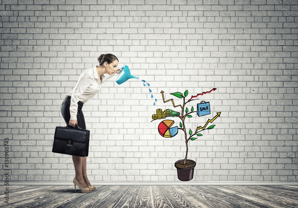 Young businesswoman in empty room watering drawn growth concept with can Young businesswoman in empty room watering drawn growth concept with can