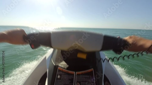 Young guy cruising on a jet ski on the sea