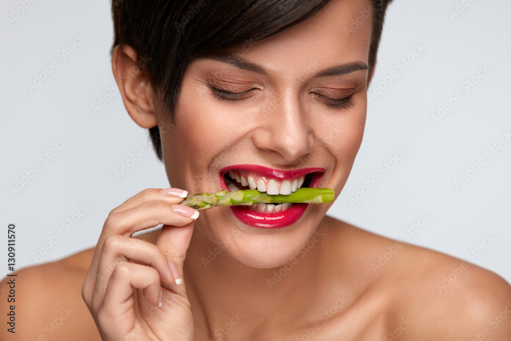 Healthy Foods. Beautiful Woman Eating Fresh Asparagus Healthy Foods. Beautiful Woman Eating Fresh Asparagus