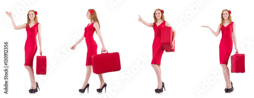 Young woman in red dress with suitcase isolated on white