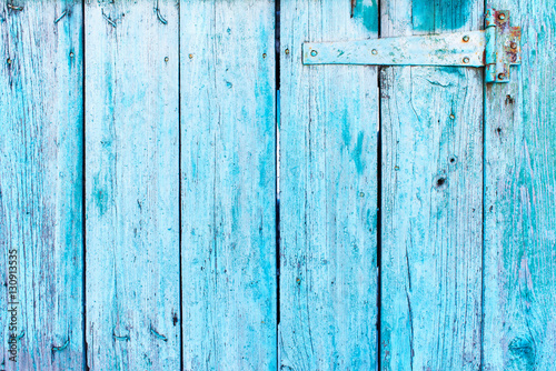 A wooden blue color door hinge closeup