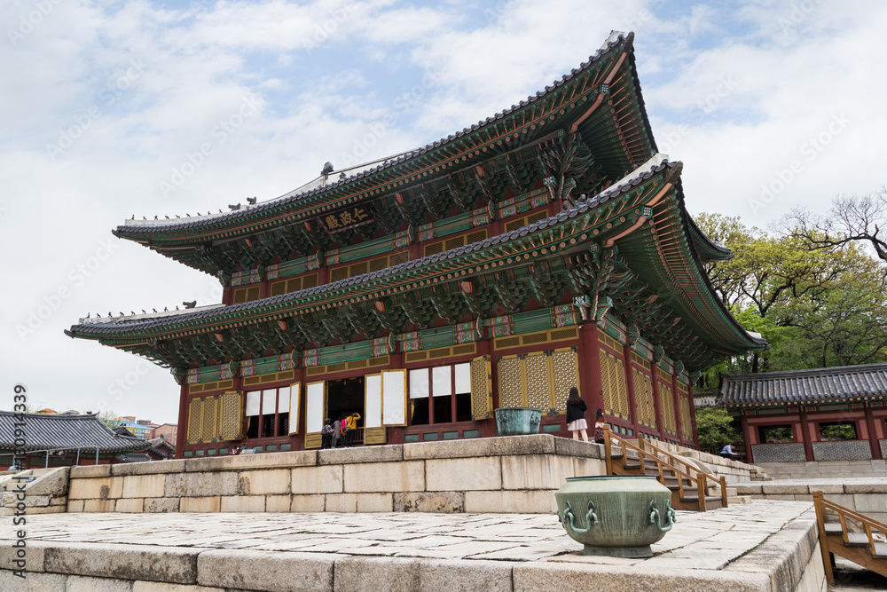 Few tourists at the Injeongjeon, the main hall of the Changdeokgung Palace in Seoul, South Korea.