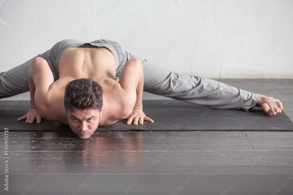 A man doing yoga exercises A man doing yoga exercises