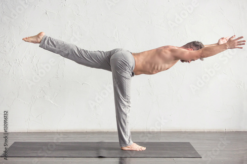 A man doing yoga exercises