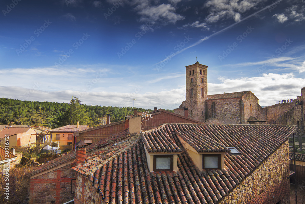 Aeriel view of bell tower of church and roof houses in medieval village of Buitrago de Lozoya, Madrid, Spain