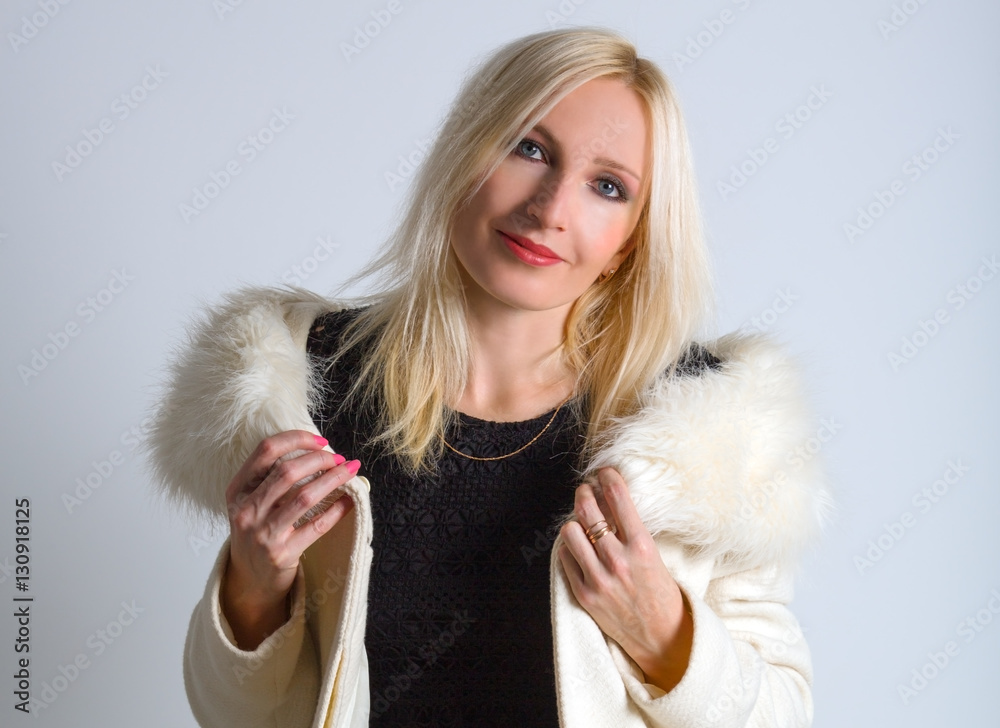 Beautiful young woman in a white autumn coat Beautiful young woman in a white autumn coat