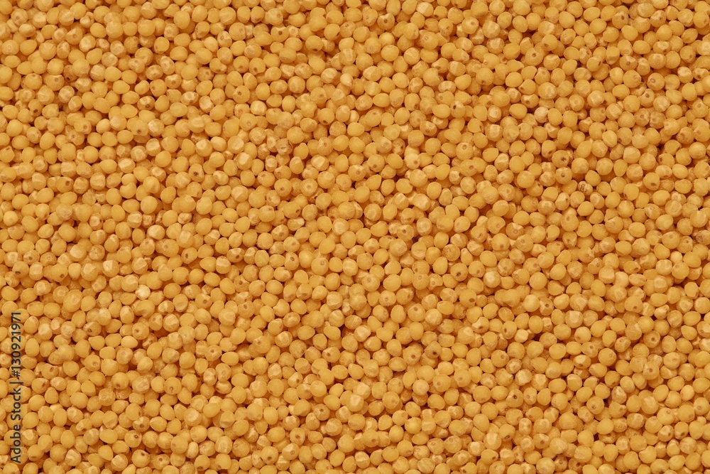 yellow millet groats background on the table top view yellow millet groats background on the table top view