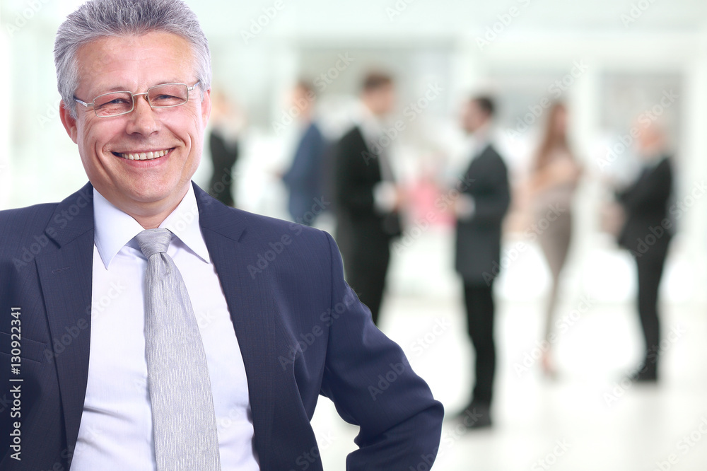 Happy mature business man looking at camera with satisfaction at office Happy mature business man looking at camera with satisfaction at office