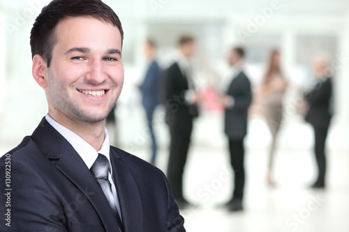Happy mature business man looking at camera with satisfaction at office