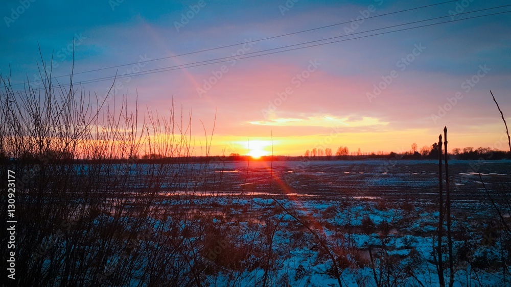 Sunset over snow-covered field