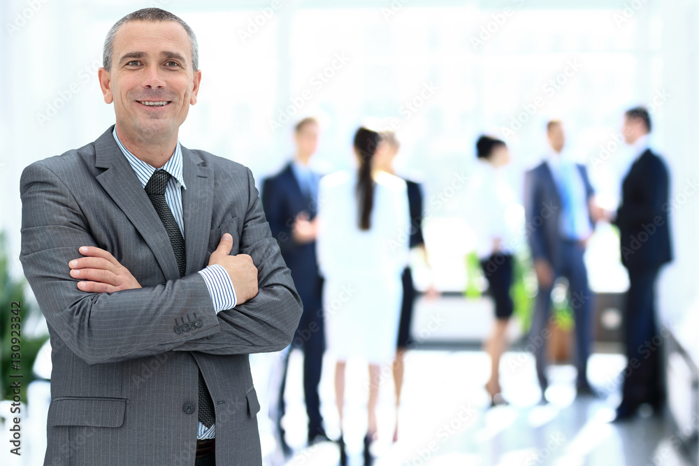 Happy mature business man looking at camera with satisfaction at office
