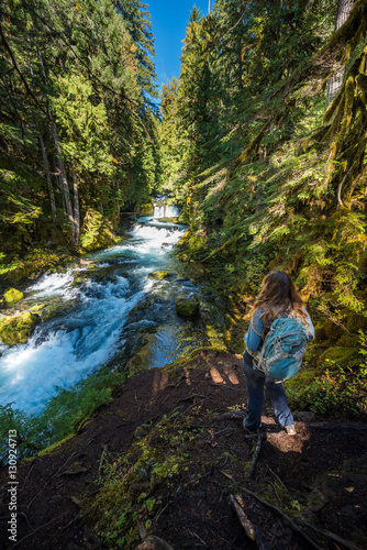 Tourist Backpacker looking at McKenzie River down from Sahalie F