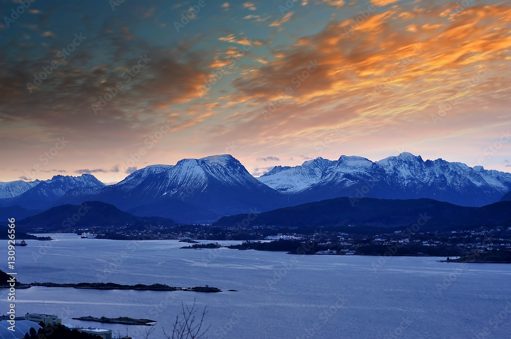 Winter Norwegian Landscape with Ocean and mountains during sunrise