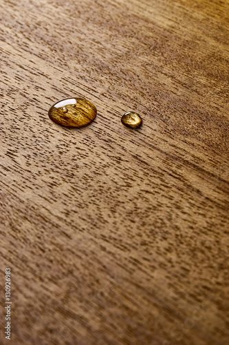 Water droplets on a wooden surface