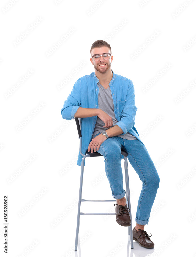 Young man sitting on the chair isolated over white background Young man sitting on the chair isolated over white background
