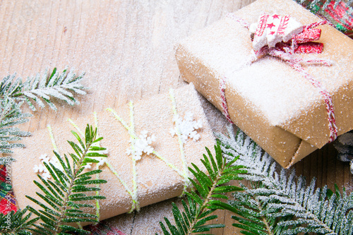 Christmas presents and snow on wooden background, retro style with copy space