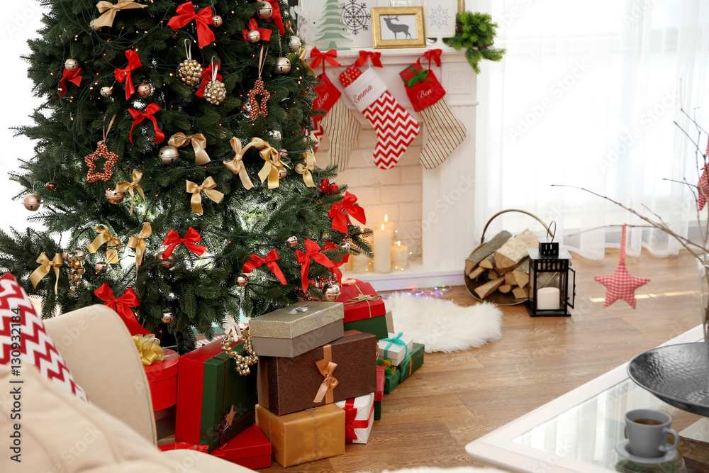 Obraz premium Interior of beautiful living room with fireplace decorated for Christmas