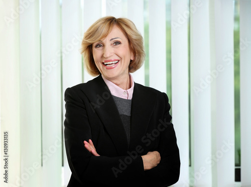 Portrait of senior successful businesswoman on light background