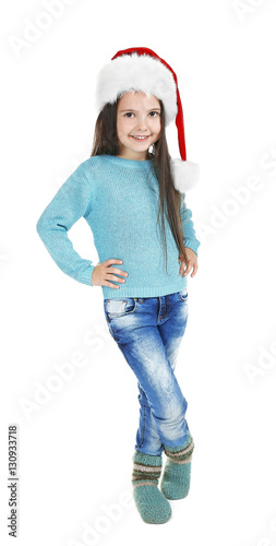 Cute little girl in Santa hat on white background