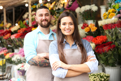 Male and female florists in flower shop
