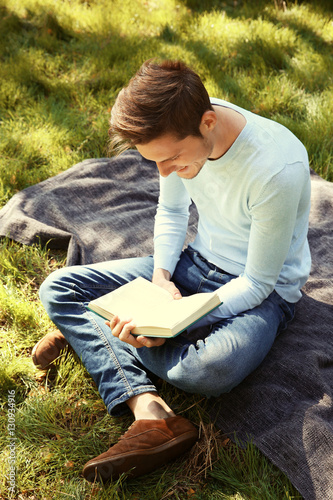Handsome man relaxing in park