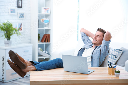 Handsome man relaxing in of...