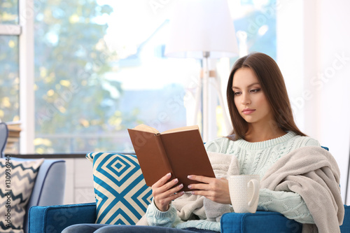 Young woman reading book si...