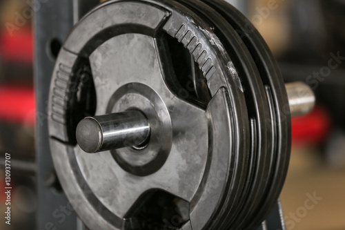 Rack with weight plates in gym, close up