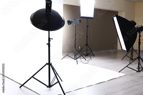 Empty photo studio with lighting equipment