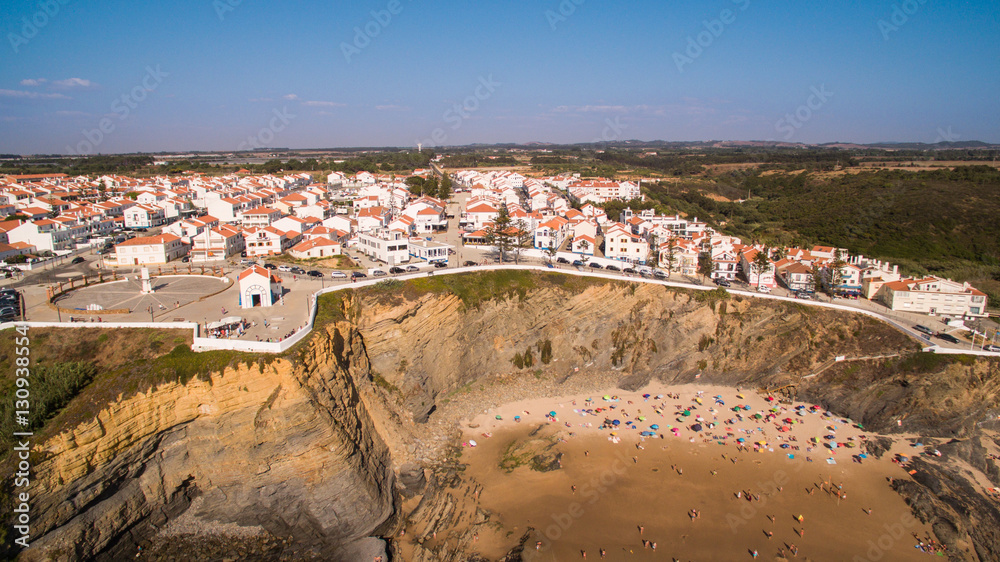 Panoramic view of Zambujeira de Mar and beach with holidaymakers people aerial