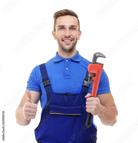 Smiling plumber holding scr...
