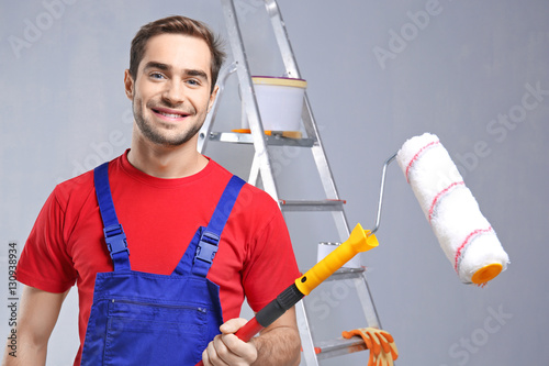 Handsome worker with paint ...