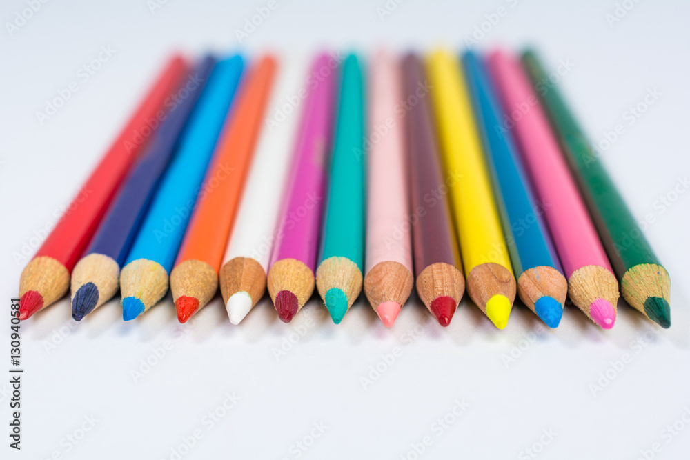 Line of Colored Pencil Crayons Isolated on White Front View Line of Colored Pencil Crayons Isolated on White Front View