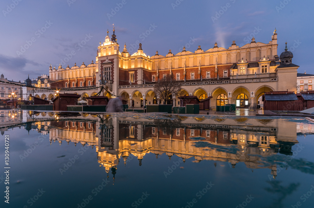 Krakow, Poland, Cloth Hall in the night, reflecting in the puddle